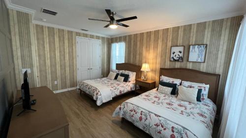 a bedroom with two beds and a ceiling fan at New Lovely Home at Sonoma Resort at Tapestry in Kissimmee