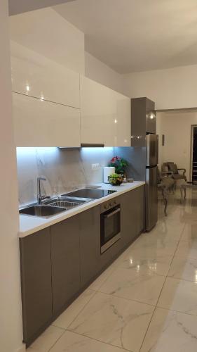 a kitchen with a sink and a refrigerator at Apartments Barbie in Rethymno Town