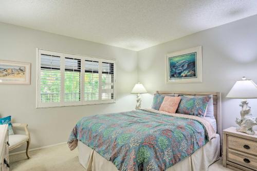 a bedroom with a bed and two windows at Luxury Sanibel Condo with Ocean View Steps to Beach in Sanibel