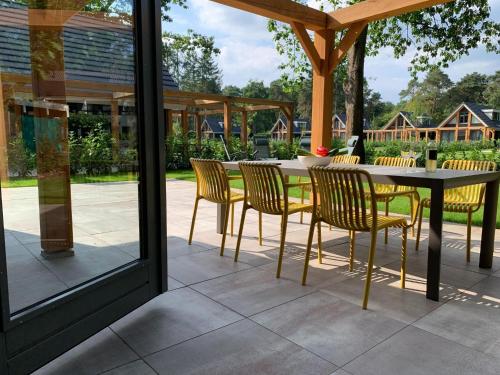 a patio with a table and chairs on a patio at Holiday Home in Lochem with Garden View in Lochem