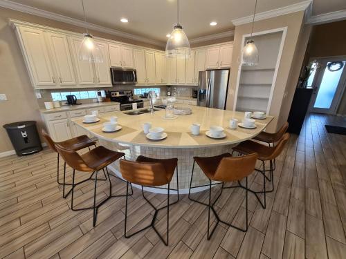 a kitchen with a large dining table and chairs at 3830 Premier Villa 6Bd Private Pool and Game Room in Kissimmee