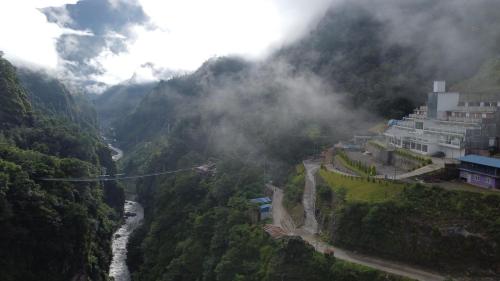 a view of a valley with a river and mountains at Bhotekoshi Heli Resort in Phalāmsāngu