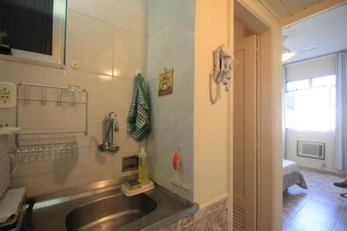 eine Küche mit einem Waschbecken und einem Telefon an der Wand in der Unterkunft Apartamento Copacabana 229 in Rio de Janeiro