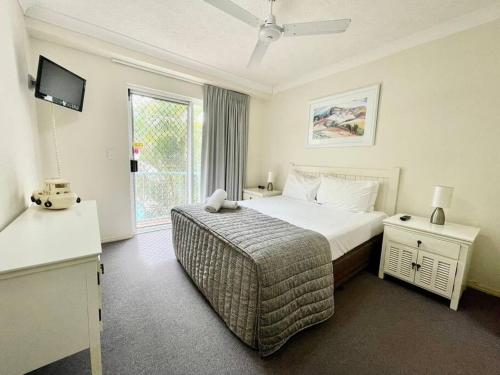 a hotel room with a bed and a window at Grande Florida Resort 66 in Gold Coast