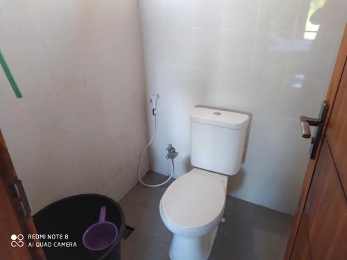 a bathroom with a toilet in a small room at Akria Bed and breakfast in Bayan