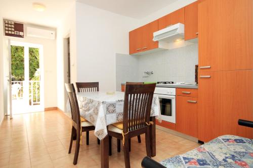 a kitchen with a table and chairs in a room at Apartments by the sea Brna, Korcula - 574 in Smokvica
