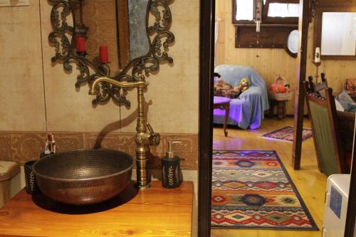 a bathroom with a bath tub on a wooden floor at budabu in Sighnaghi