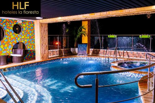 a large swimming pool in a hotel at night at La Floresta de Cite Hotel in Cite
