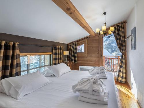 a bedroom with a bed with white pillows on it at Chalet Saint-Martin-de-Belleville, 4 pièces, 8 personnes - FR-1-570-17 in Saint-Marcel