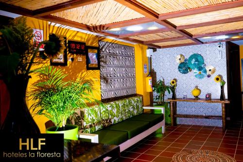 a room with a couch and plants on the wall at La Floresta de Cite Hotel in Cite