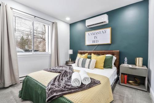 a bedroom with a bed with towels on it at Beautiful Mount Pocono Chalet with Hot Tub!! in Tobyhanna