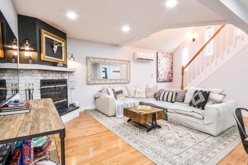 a living room with a couch and a fireplace at Beautiful Mount Pocono Chalet with Hot Tub!! in Tobyhanna