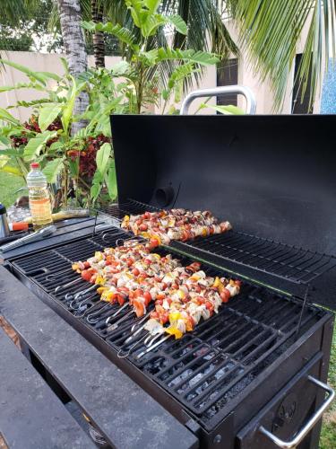 a bunch of food on a barbecue grill at Coral Island Suites Cozumel in Cozumel