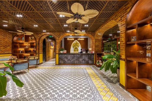 a lobby of a restaurant with a tile floor at Boutik Cham NhaTrang Hotel in Nha Trang