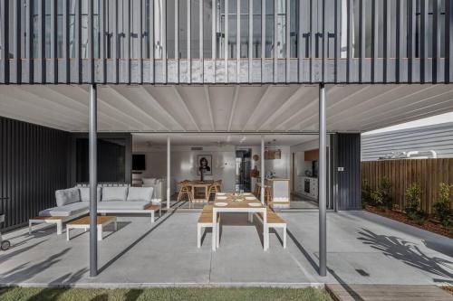 a living room with a couch and a table at Sanctuary Spaces - Lomani Eleven in Byron Bay