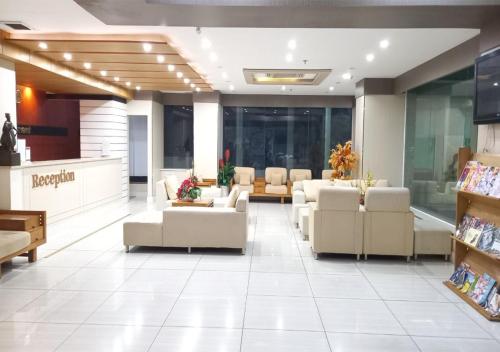 a waiting room with couches and chairs in a store at Khai Hoan Apartment Hotel in Ho Chi Minh City