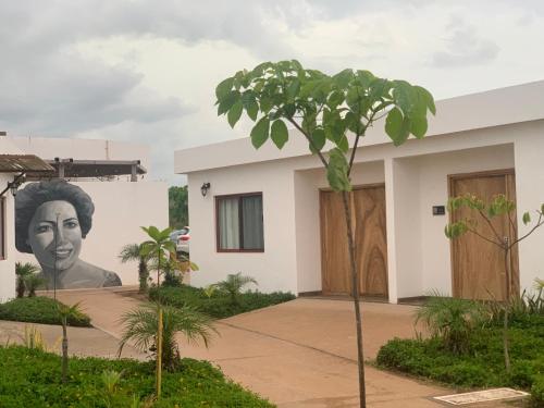 a mural of a woman on the side of a building at Playa Esperanza Resort in Celestino Gasca
