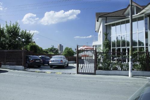 a parking lot with cars parked in front of a building at Villa Grande in Iaşi
