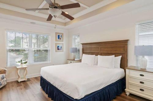 a bedroom with a large bed with a ceiling fan at Beautiful 4 bedroom near Rosemary Beach! in Inlet Beach