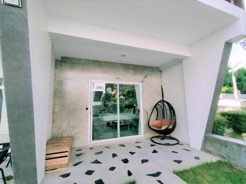 a room with a chair and a window at Makan Resort in Kanchanaburi