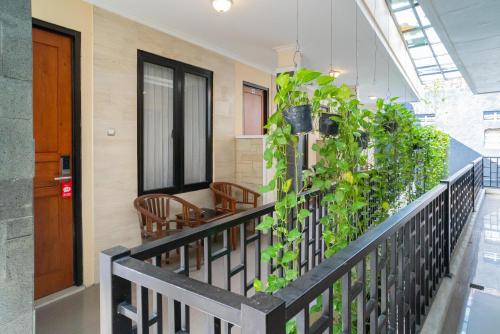 a balcony with plants on the railing of a building at RedDoorz Plus Syariah @ Jalan Dokter Wahidin Bojonegoro in Bojonegoro
