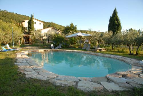 a swimming pool in a yard with a house at La Finestra su Cortona in Cortona