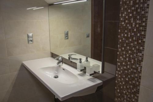 a bathroom with a white sink and a mirror at Restaurace a Penzion U Klásků in Olomouc