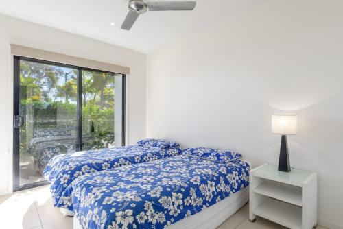 a bedroom with two beds and a window at Rainbow Surf 5 in Rainbow Beach