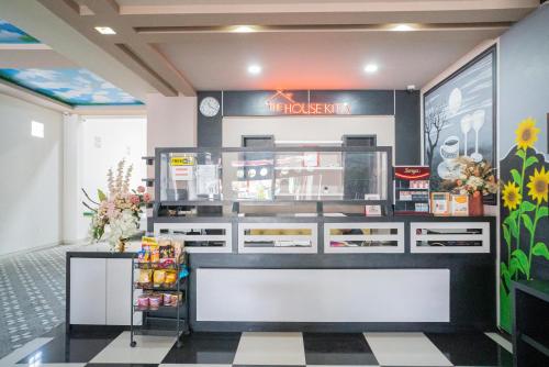 a fast food restaurant with a front counter and flowers at RedDoorz Plus @ Jalan Pemuda Timur Bojonegoro in Bojonegoro