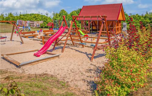a playground with a slide in the sand at Nice Home In Jaroslawiec With 2 Bedrooms in Jarosławiec