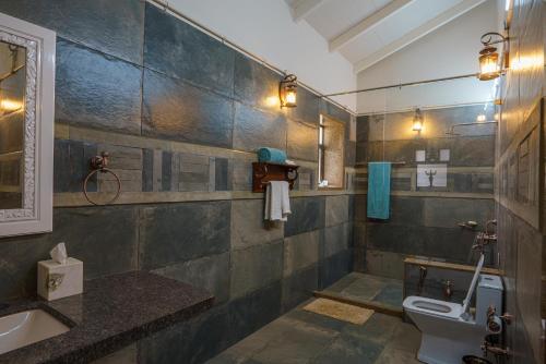 a bathroom with a toilet and a sink at ama Stays & Trails Mirayan, Nashik in Trimbak