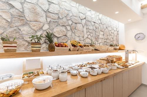 a buffet with bread and pastries on a counter at Spiros in Naxos Chora