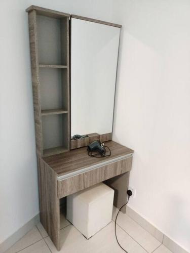 a dressing table with a mirror on a wall at Almas Suite Seaview & Netflix By STAY in Nusajaya