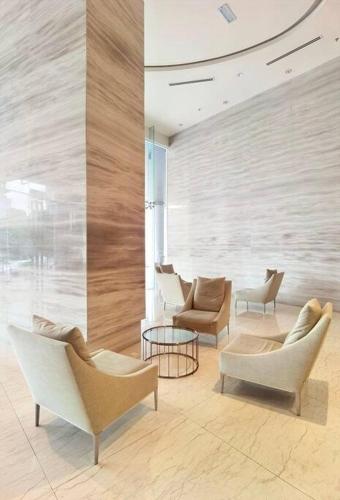 a lobby with couches and chairs in a building at Almas Suite Seaview & Netflix By STAY in Nusajaya