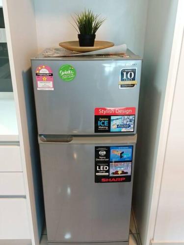 a refrigerator with a plant on top of it at Almas Suite Seaview & Netflix By STAY in Nusajaya