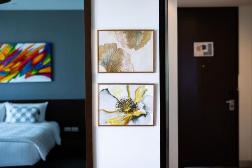 a room with three framed pictures on the wall at Happy Apartment on Karon Beach in Karon Beach