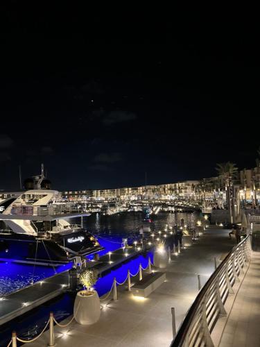 a boat docked at a marina at night at Elegant 1BR Chalet at Marassi Marina 2 in El Alamein
