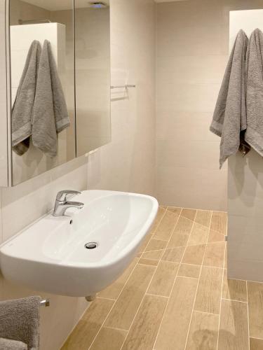 a bathroom with a sink and a mirror at Chalet Alte Post in Schwarzsee