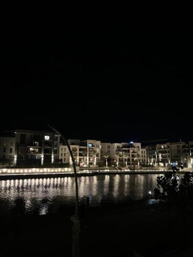 a light pole in the water at night at Elegant 1BR Chalet at Marassi Marina 2 in El Alamein