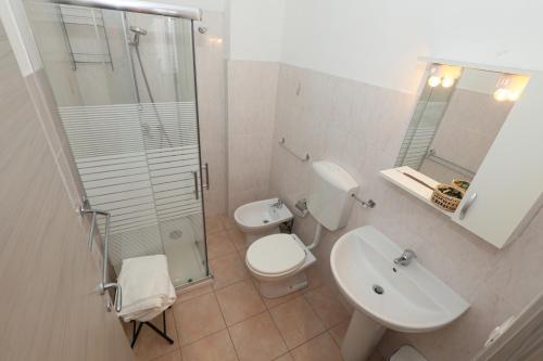 a bathroom with a toilet and a sink and a shower at Affittacamere "SAN MARTINO ROOMS" in Genova
