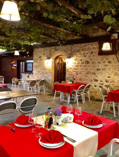 a dining room with red tables and chairs at Hotel - Kulla e Zenel Beut in Peje