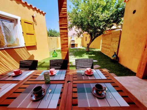 a wooden table with plates of food on it at villa Sara in Teulada