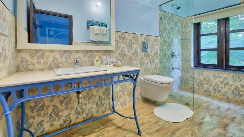 een badkamer met een toilet, een wastafel en een douche bij Ikaki Niwas - A Heritage Boutique Hotel in Jaipur