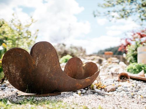 a rusty metal heart sitting on the ground at Chalet in Feistritz near Petzen Ski Area in Unterlibitsch