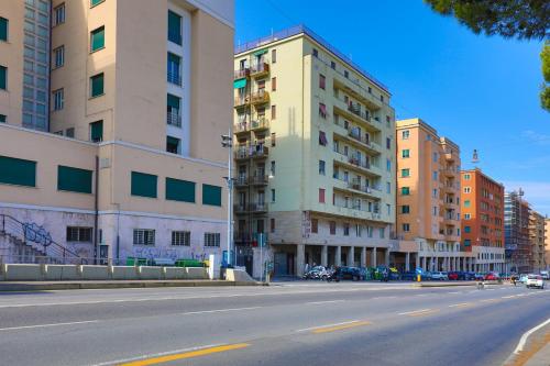 an empty street in a city with tall buildings at Affittacamere "SAN MARTINO ROOMS" in Genova