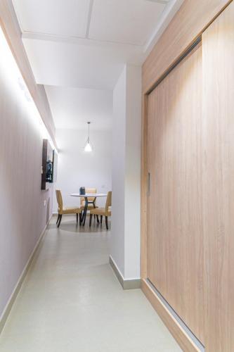 a hallway with a table and a wooden door at Hotel Deccan Serai Grande, Gachibowli, Hyderabad in Hyderabad