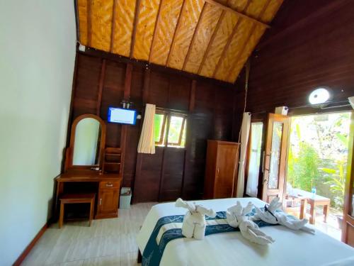 a bedroom with a bed with towels on it at Exotic View Cottage in Nusa Penida