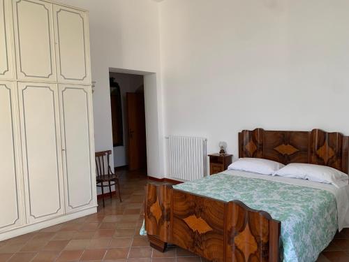 a bedroom with a bed and a large white cabinet at Guest house Il Palazzo Marchesale in Carife