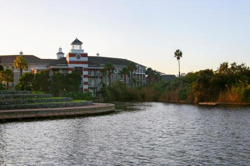 a building with a clock tower next to a river at Knightsbridge 407 by Host Agents in Cape Town
