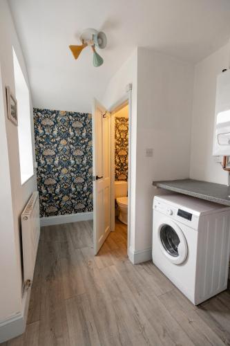 a laundry room with a washer and dryer at Daffodil House in Cockermouth